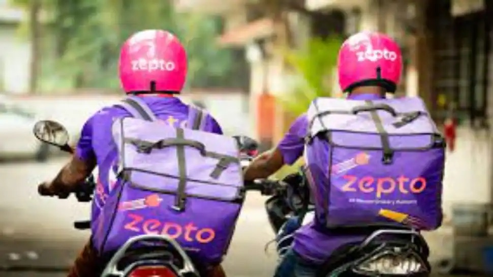 Two delivery men on a Zepto delivery bike. 