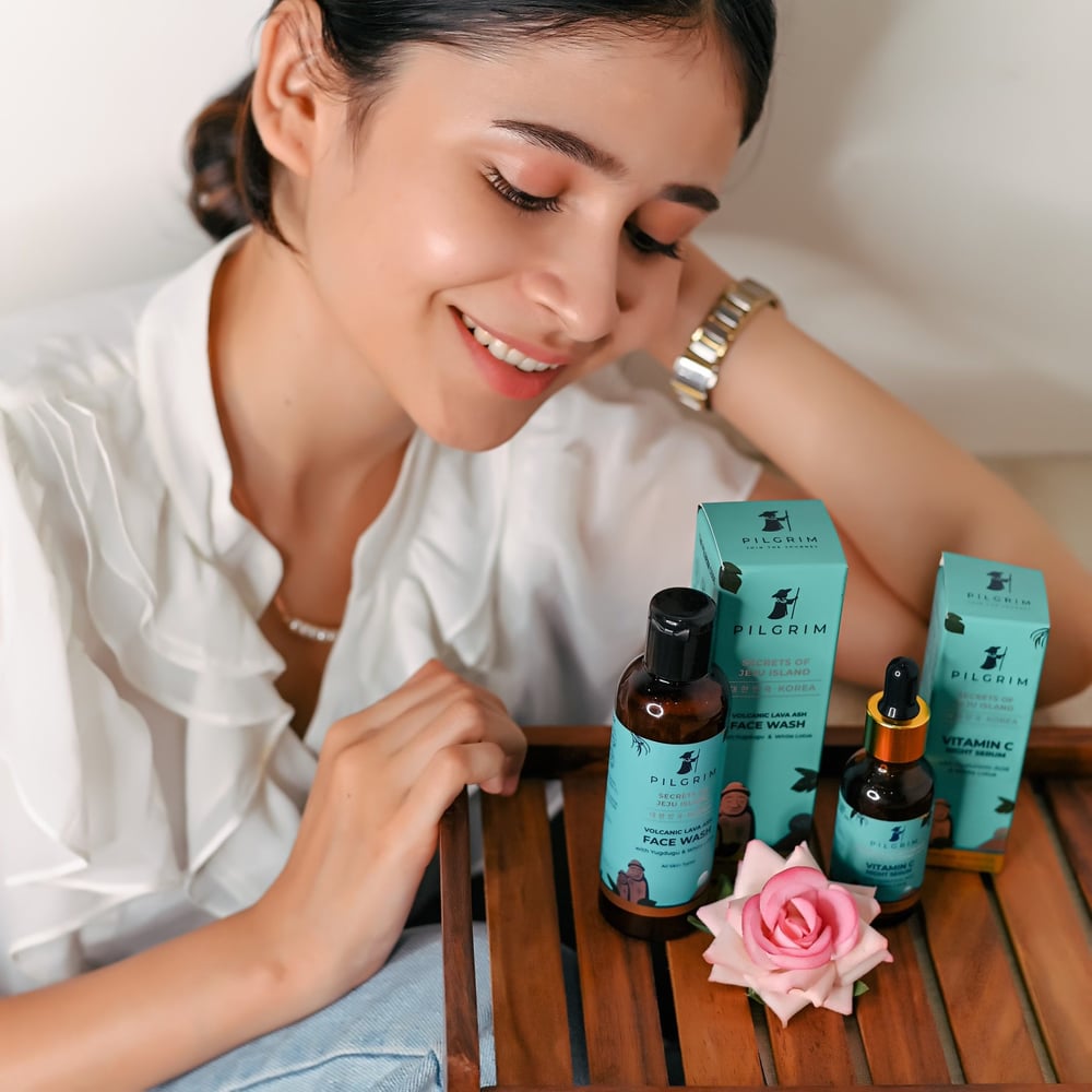 A woman sitting with two products offered by Pilgrim.