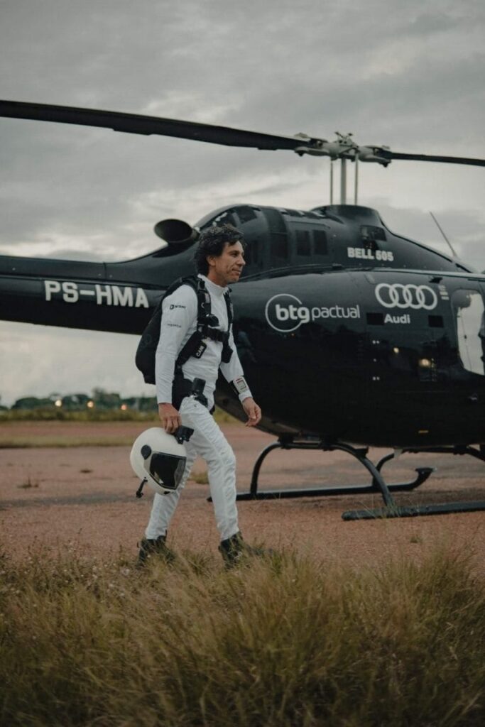 Luigi Cani in front of a helicopter. 