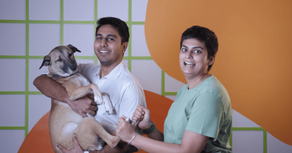 Sploot co-founders Garima Kaushal and Arnav Sahni with Arnav holding a dog. 