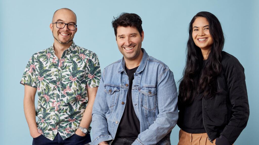 Canva's co-founder Cameron Adams (L), Cliff Obrecht (M), and Melanie Perkins (R) posing together